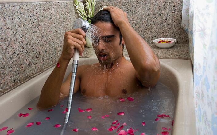 A man takes a contrast shower to increase his strength