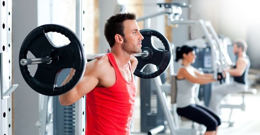 The man lifts the bar